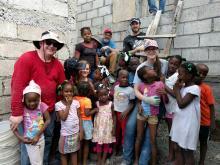 Team members with Haitian children