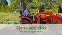 Boy on tractor plowing a field