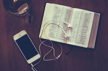 Bible with iPhone, earbuds and tea