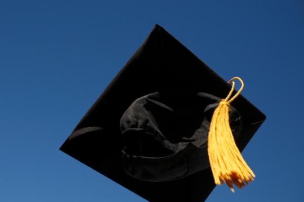 graduation cap in air